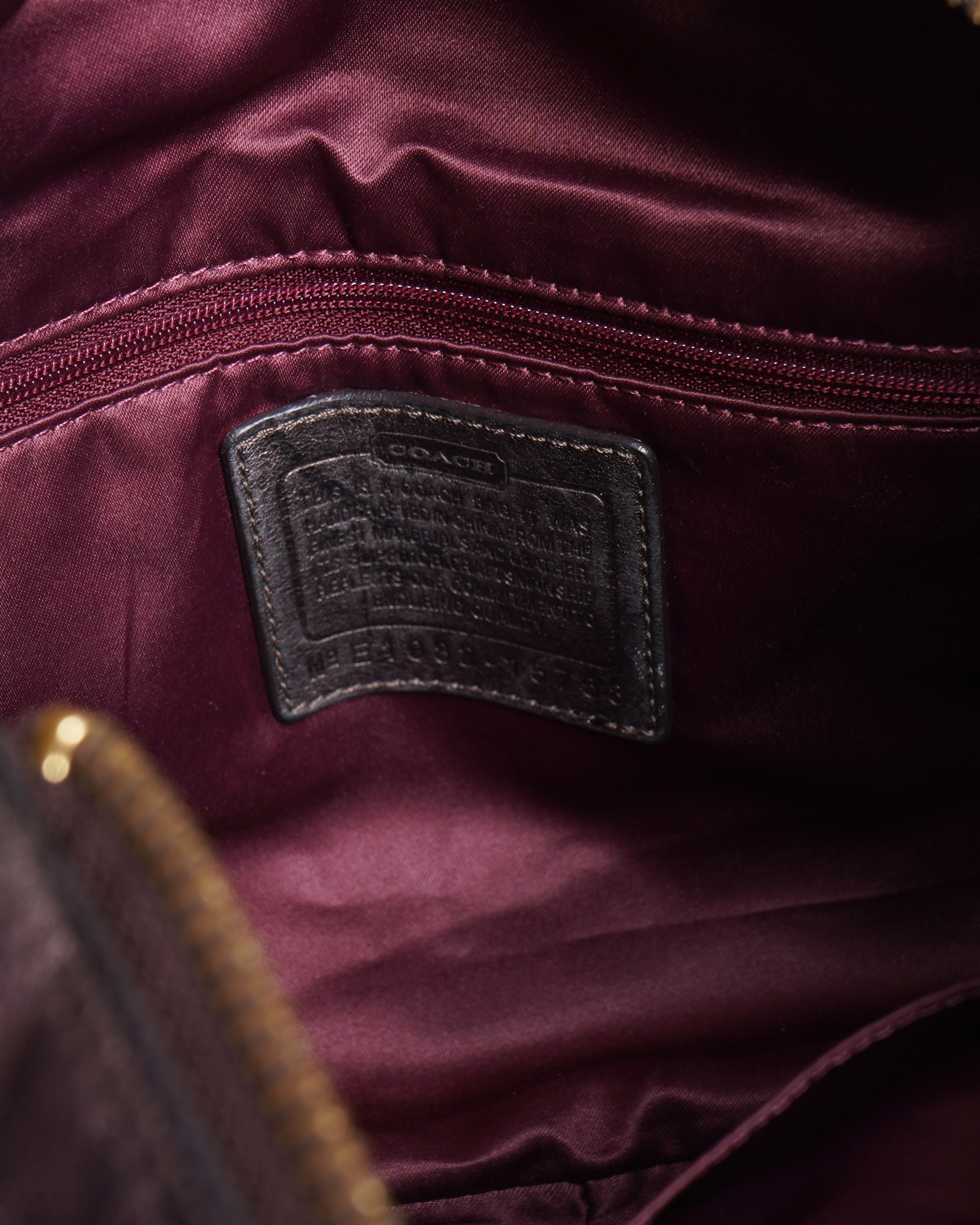 Coach 
Op art fabric signature leather bag