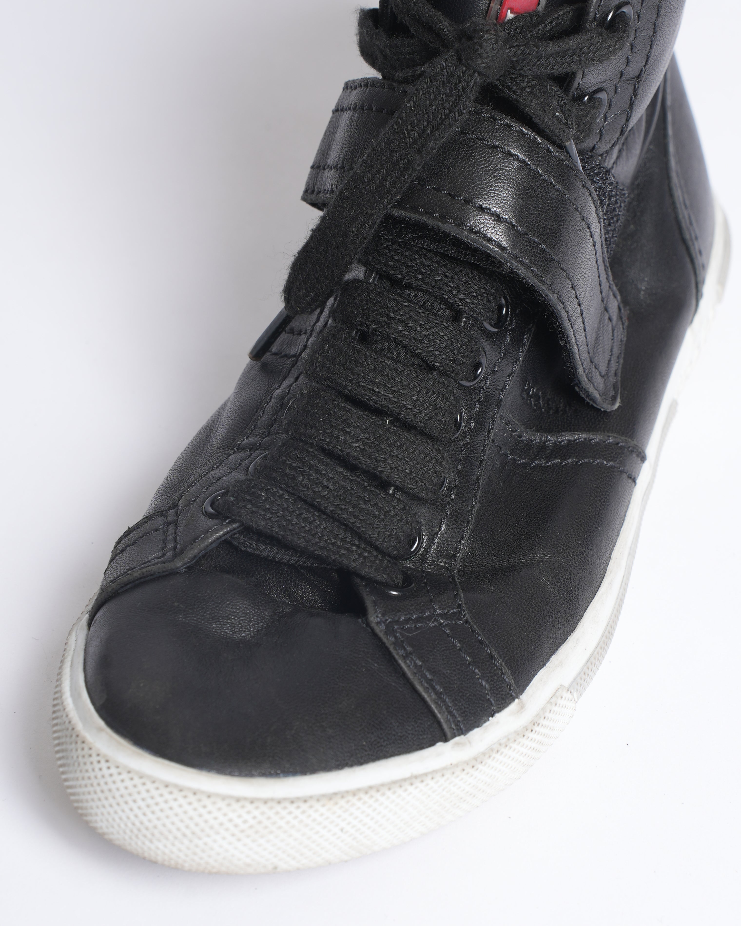 Prada high top black leather sneakers