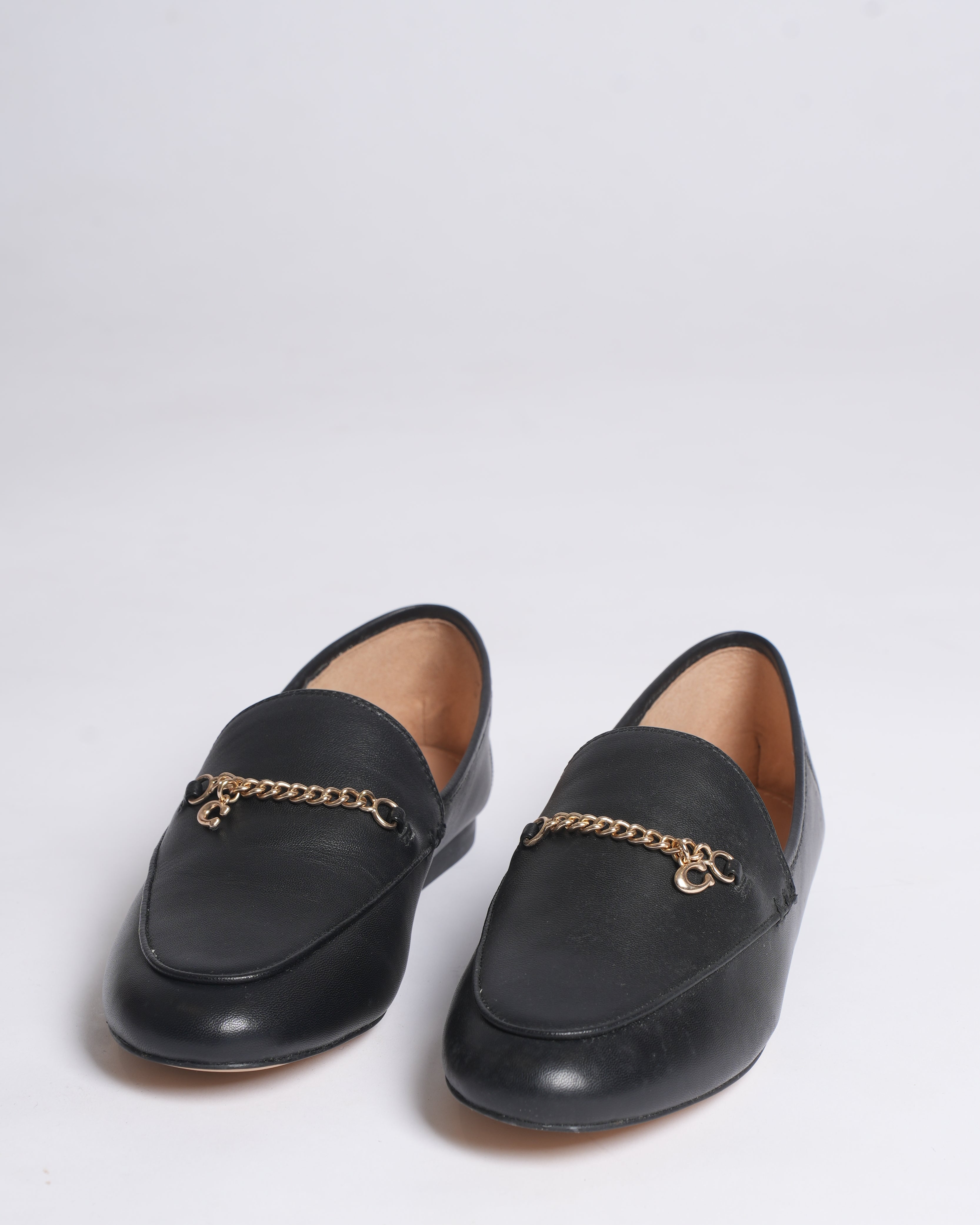 New Coach Hanna loafers in black with a gold-tone chain