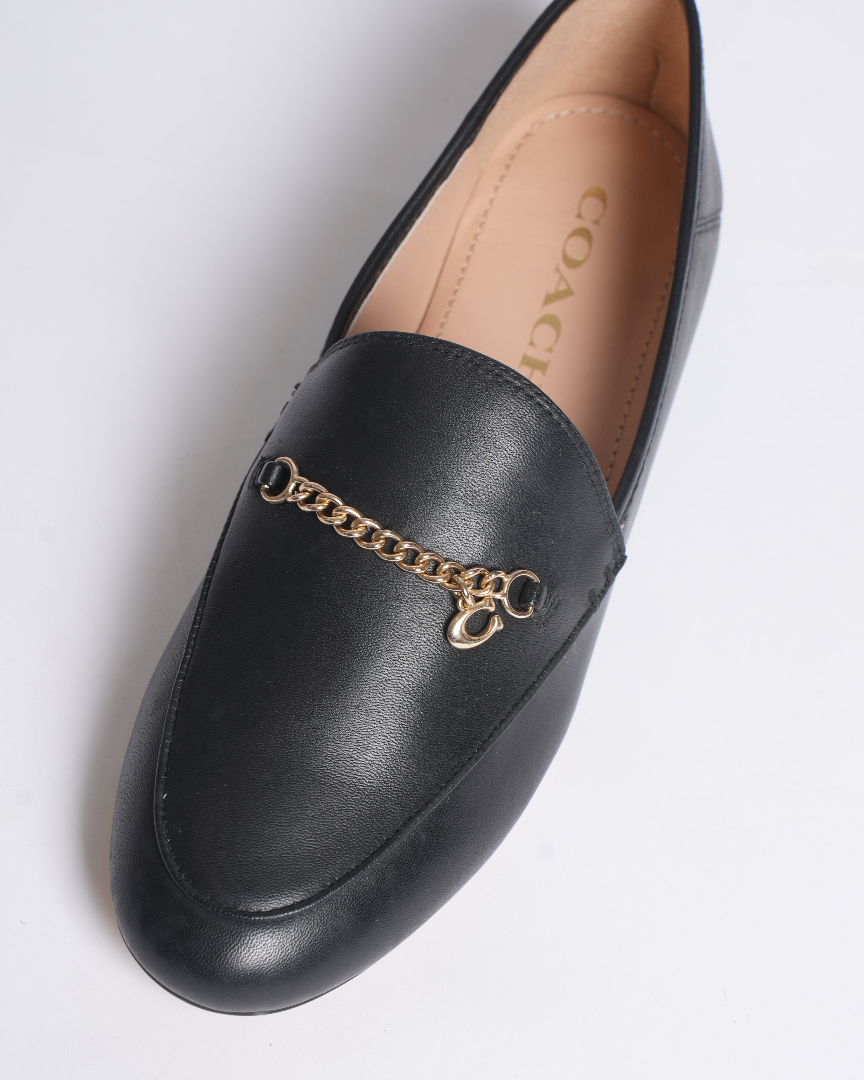 New Coach Hanna loafers in black with a gold-tone chain