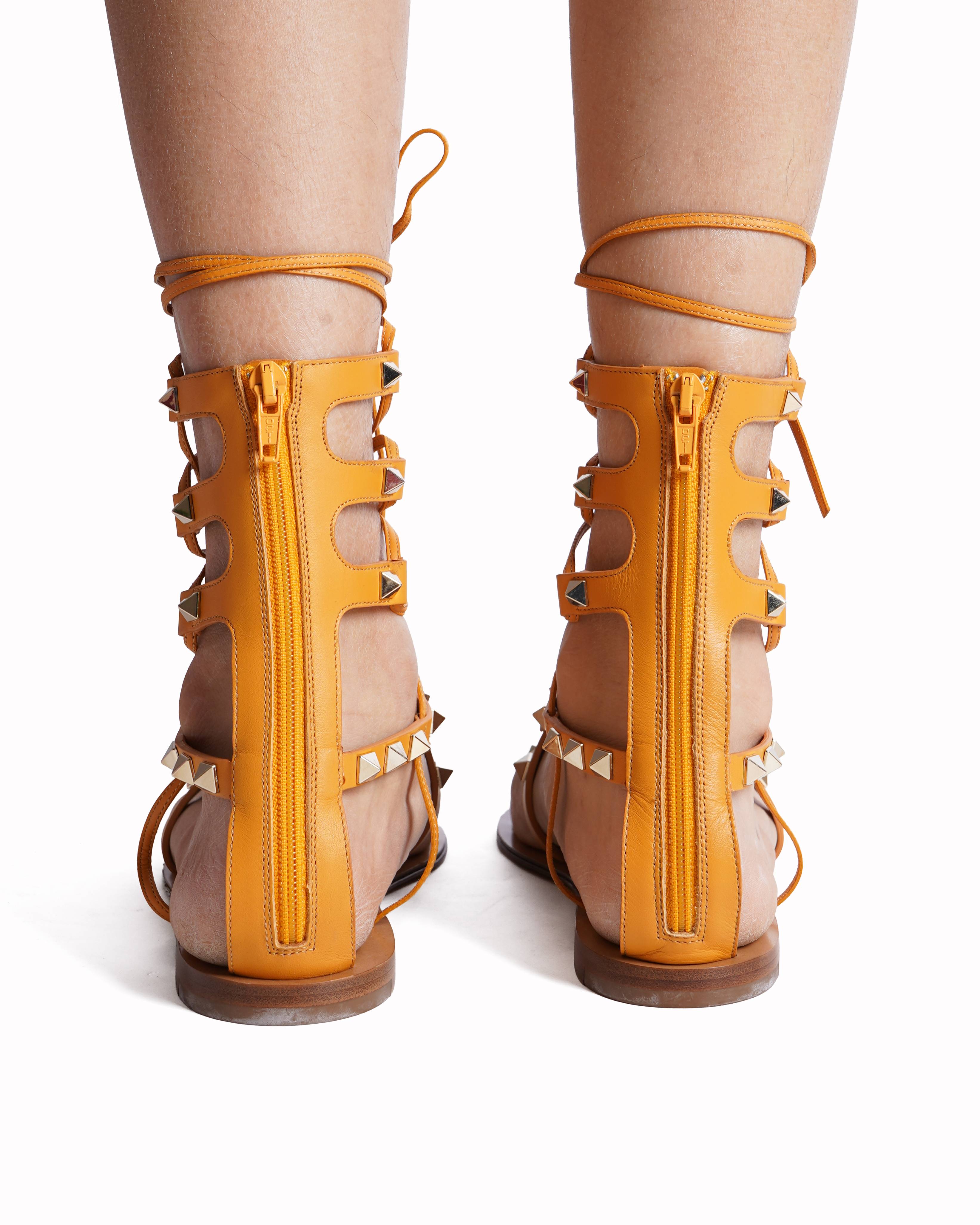 Valentino Garavani Rockstud Gladiator Flat Sandals In Mustard