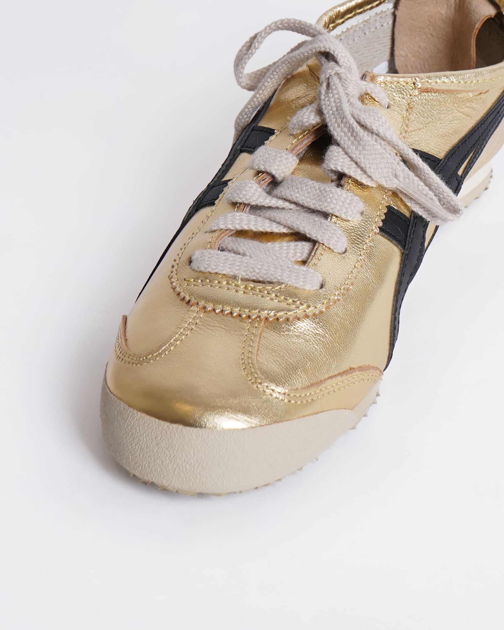 Onitsuka gold and black sneakers